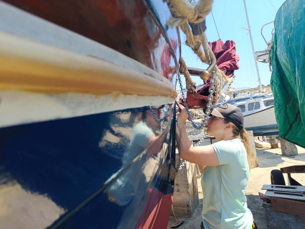 Full-time boat building students working on a wooden hull — 40 Weeks Professional Program at Seamanship Academy