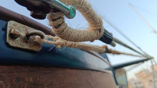 Close-up of traditional rope rigging and a bronze shackle on a wooden hull — Rigging, Sail & Marlinspike courses at Seamanship Academy