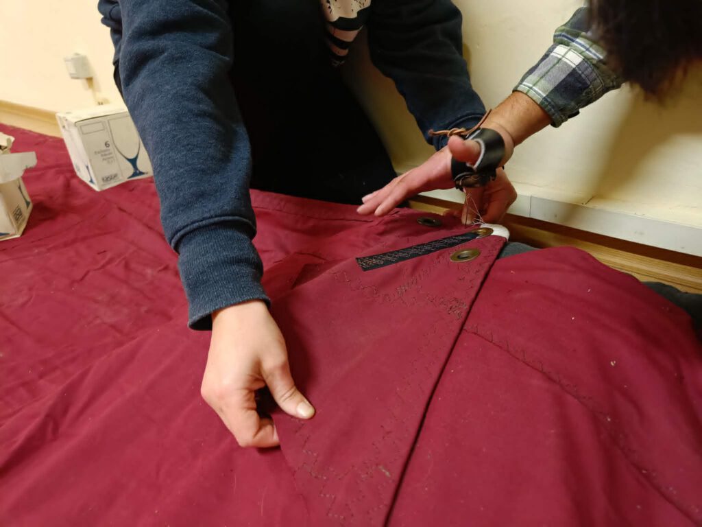 Sailmaking students working on a full sail project at Seamanship Academy